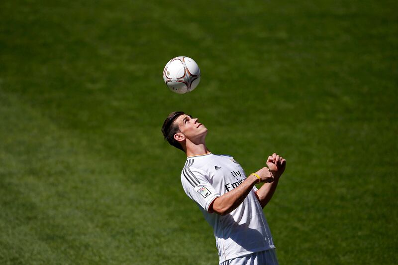 Gareth Bale of Wales heads a ball at the Santiago Bernabeu stadium in Madrid, September 2, 2013. Thousands of Real Madrid fans flocked to the Bernabeu to welcome Gareth Bale on Monday after the nine-times European champions sealed the purchase of the Wales winger from Tottenham Hotspur for what the London club said was a world record fee.   REUTERS/Sergio Perez (SPAIN  - Tags: SPORT SOCCER BUSINESS)   *** Local Caption ***  JMR15_SOCCER-SPAIN-_0902_11.JPG