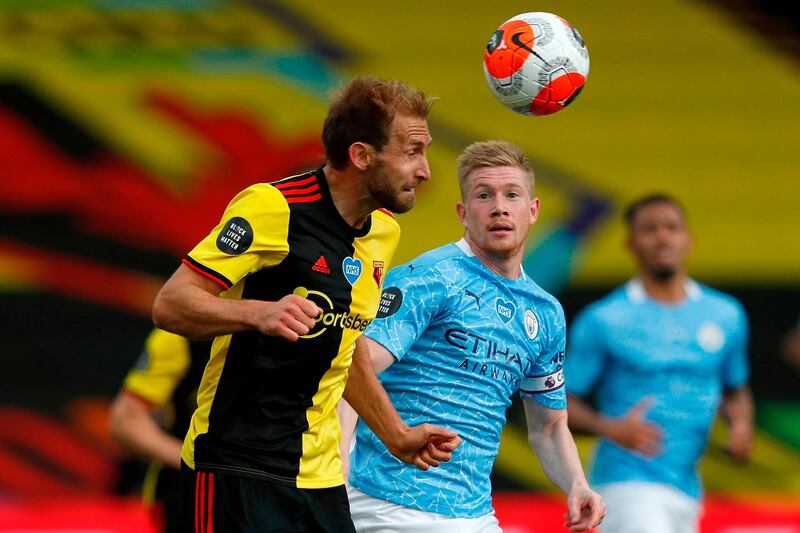 Watford's Craig Dawson vies for the ball with Manchester City's Kevin De Bruyne. AFP