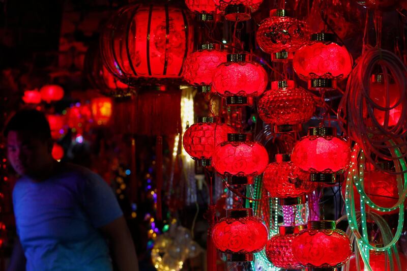 A Cambodian man walks past red lanterns at a store set up for Chinese New Year in Phnom Penh, Cambodia.  EPA