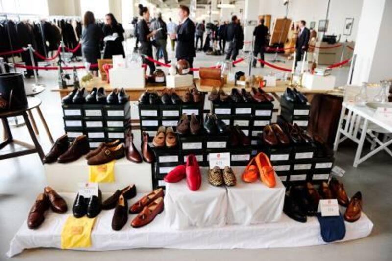 Shoes which belonged to disgraced financier Bernie Madoff, are displayed during a press preview of items from Madoff to be auctioned, at the Brooklyn Navy Yard, November 10, 2010. Hundreds of items once belonging to Madoff will be auctioned off on November 13, 2010, running the gamut from a massive emerald-cut diamond to his black bedroom slippers, US officials said. Proceeds from the auction will compensate the victims of his multibillion USD Ponzi scheme. TOPSHOTS/AFP PHOTO/Emmanuel Dunand

 *** Local Caption ***  627082-01-08.jpg