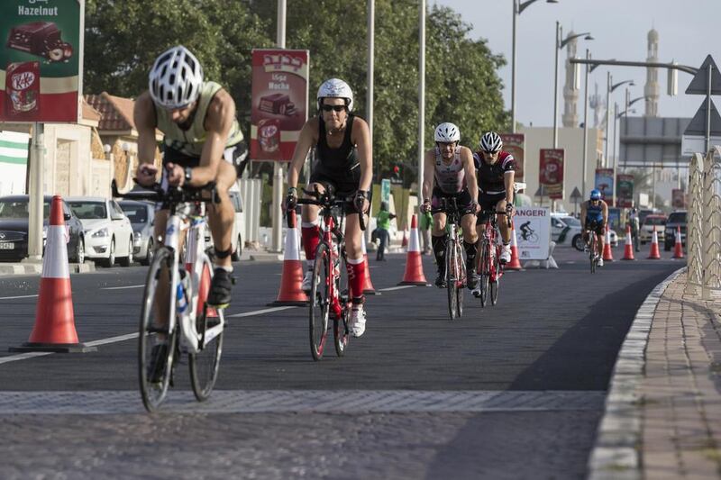 DUBAI, UNITED ARAB EMIRATES, 29 JANUARY 2016. The Ironman 70.3 Dubai Triathlon held on Sunset Beach next to the Burj Al Arab. General contestants take part in the cycle stage of the race. (Photo: Antonie Robertson/The National) ID: None. Journalist: None. Section: Sport.