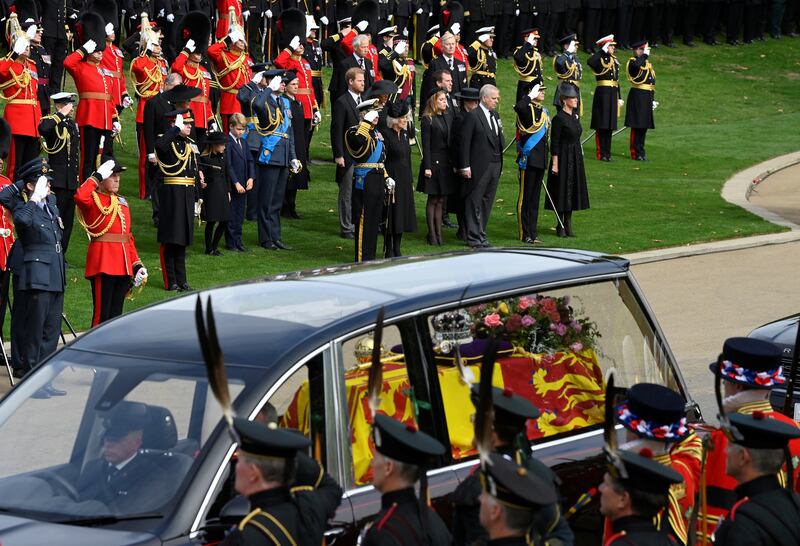 Members of the royal family pay their respects as the hearse carries the coffin of Queen Elizabeth in London. Reuters