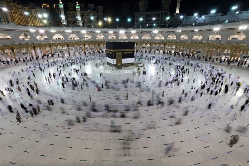 Walking around the Kaaba, Islam's holiest shrine, at the Grand Mosque.