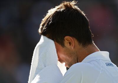 epa07432657 Novak Djokovic of Serbia wipes his face with a towel as he plays against Philipp Kohlschreiber of Germany during the BNP Paribas Open tennis tournament at the Indian Wells Tennis Garden in Indian Wells, California, USA, 12 March 2019. The men's and women's final will be played, 17 March 2019.  EPA/LARRY W. SMITH