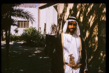 Sheikh Zayed at Qasr Al Hosn in the shade of palm trees, 1966. Courtesy Nick Cochrane-Dyet
