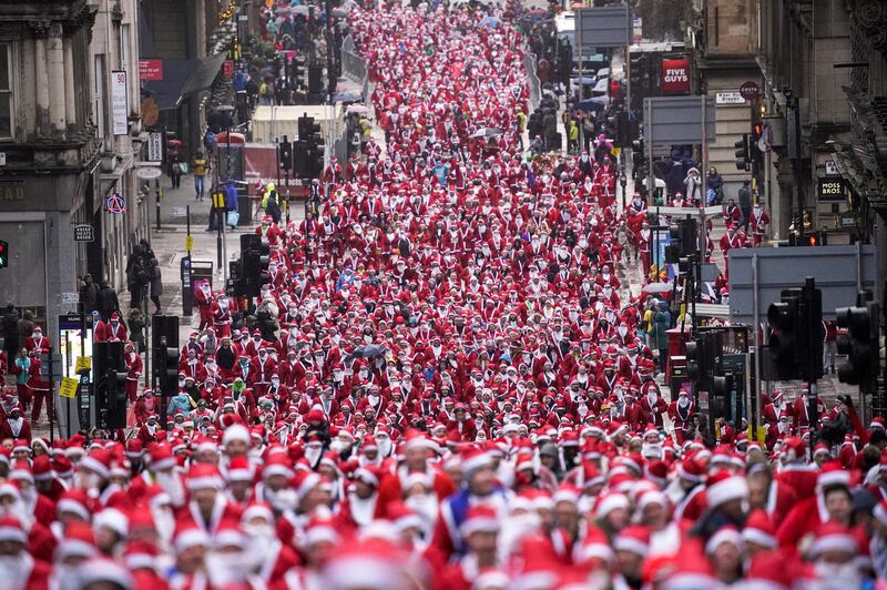 Thousands of Scots dressed in Santa suits make their way through the streets of Glasgow to raise money for charity. Getty Images
