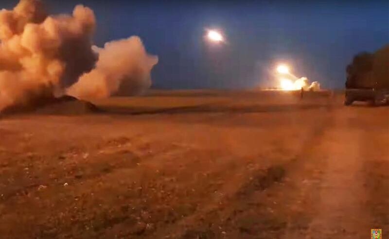 In this image taken from video released by Azerbaijan's Defense Ministry on Wednesday, Oct. 21, 2020, Azerbaijan's army artillery fire during fighting with forces of the self-proclaimed Republic of Nagorno-Karabakh. Azerbaijan's President Ilham Aliyev said that to end hostilities Armenian forces must withdraw from Nagorno-Karabakh. He has insisted that Azerbaijan has the right to reclaim its territory by force after nearly three decades of international mediation yielded no progress. (Azerbaijan's Defense Ministry via AP)