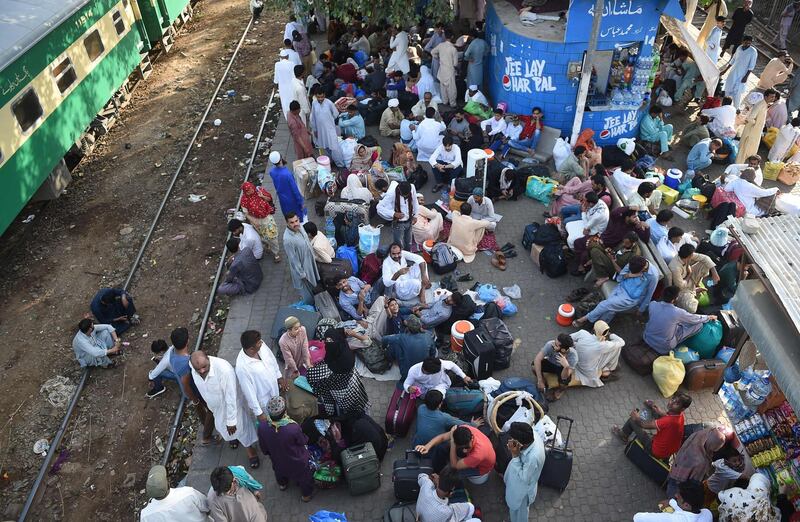 Pakistani people wait for the train to travel back home to be with their families ahead of the Muslim festival of Eid Al Fitr, in Karachi. AFP