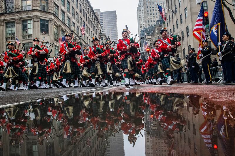 Bagpipers march up Fifth Avenue past St Patrick's Cathedral during the St Patrick's Day Parade in New York.  Celebrations across the country are back after a two-year hiatus in a sign of growing hope that the worst of the coronavirus pandemic may be over. AP Photo