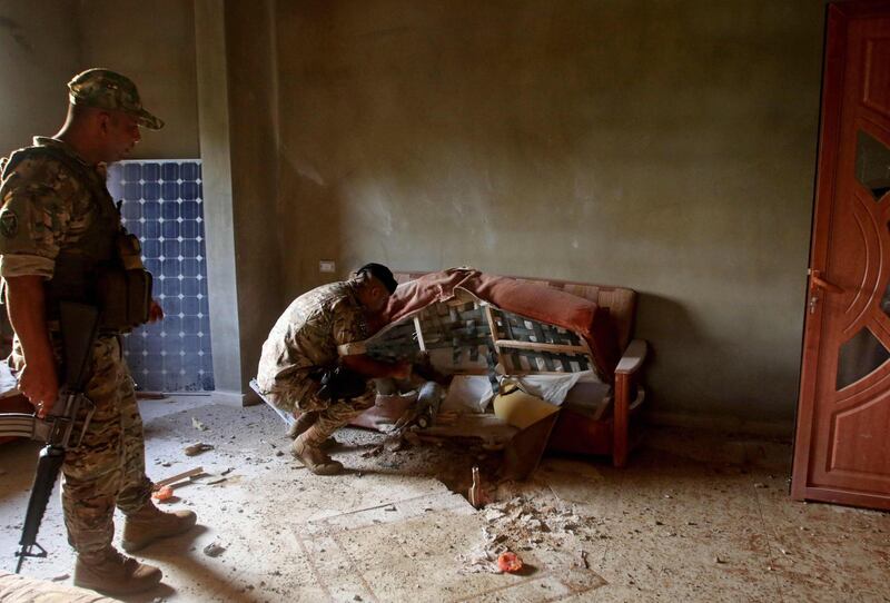 A bomb expert from the Lebanese army inspects an unexploded ordnance inside a home in Hebarieh village, after reported Israeli bombardment of the Shebaa Farms area. AFP