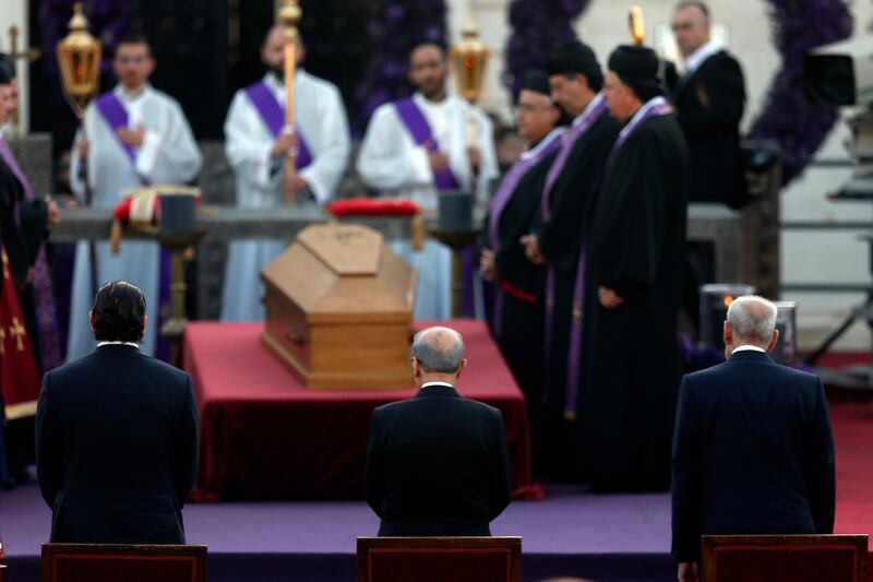 Lebanese Prime Minister Saad Hariri, left, President Michel Aoun and House Speaker Nabih Berri stand in front of the coffin. AP Photo
