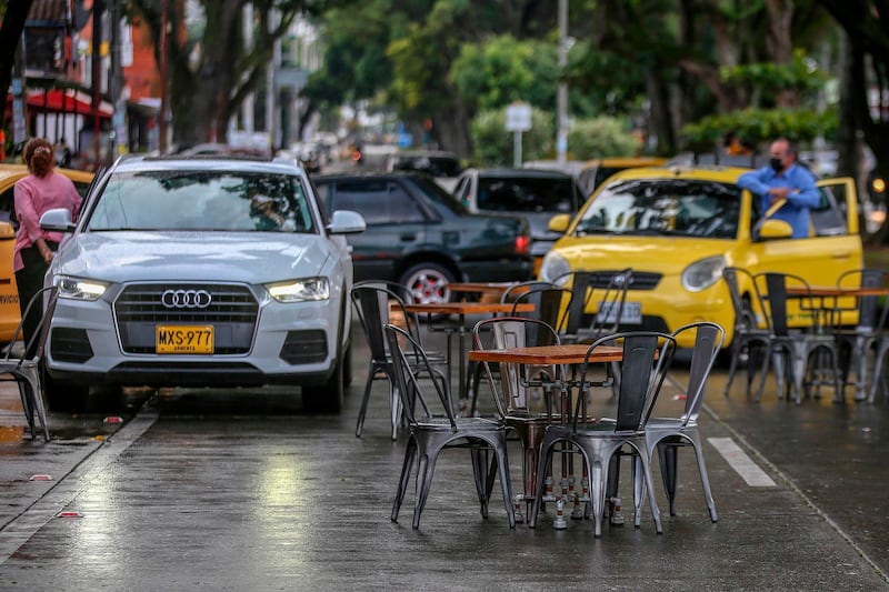 Restaurant tables block a street during a protest of the sector against the measures taken by the national government to prevent the Covid-19, in Cali, Colombia. AFP