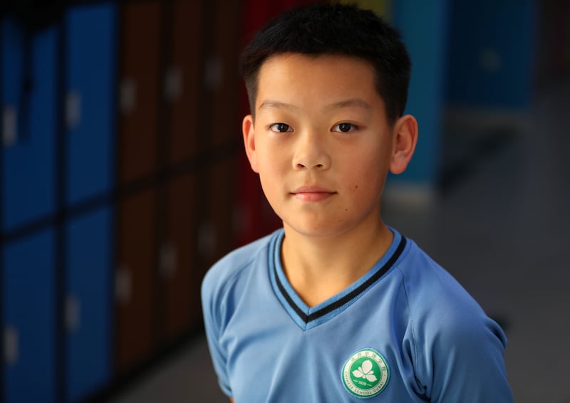 Lingeng Qing, 11, says the opening of the Chinese-curriculum school gives him the chance to live with his father, who has been working in Dubai for more than 10 years