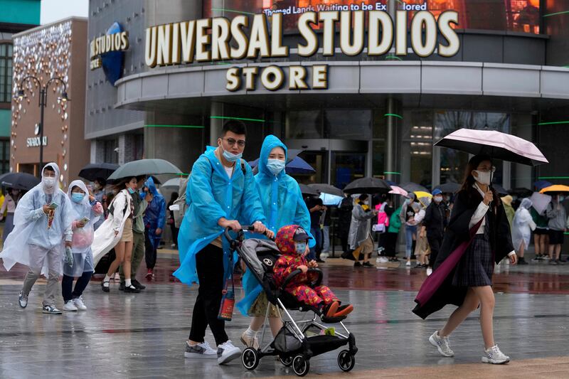 Thousands of people brave the rain to visit the newest location of the global brand of theme parks. AP Photo