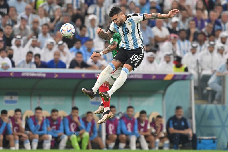 Mexico's Alexis Vega in an aerial battle with Argentina defender Nicolas Otamendi, right. AFP