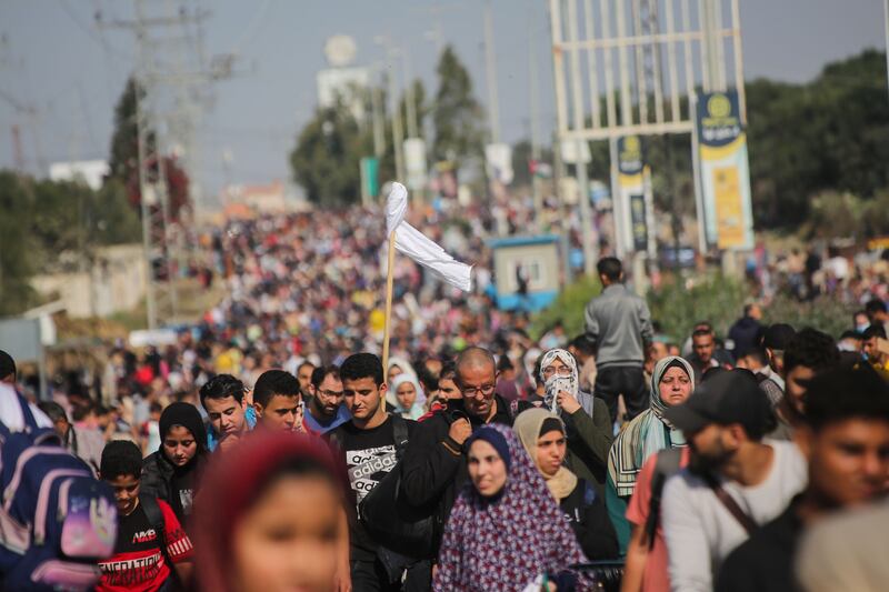 Palestinian citizens displaced from Gaza city walk south along Salah Al Din Road on November 10. Under the imminent truce, freedom of movement is guaranteed along the route. Getty