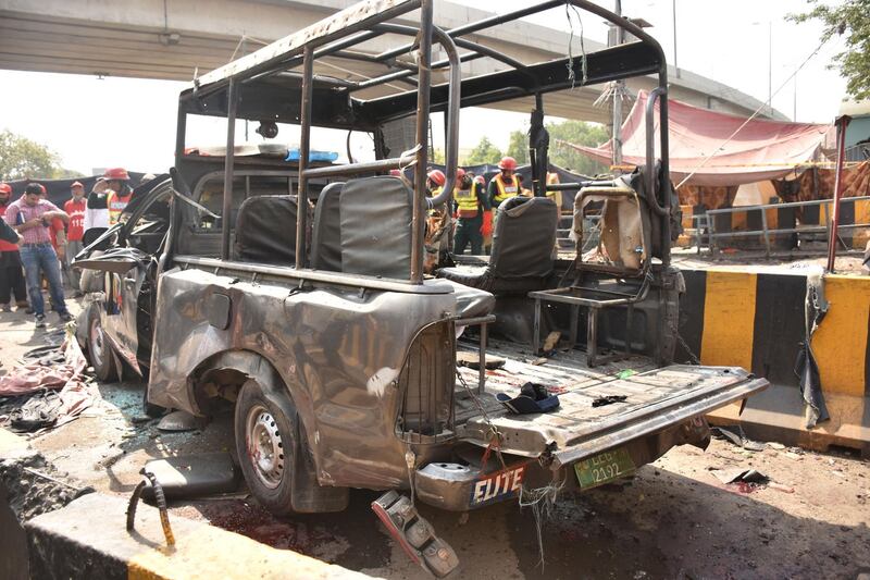 Officials examine the site of the bomb blast. EPA