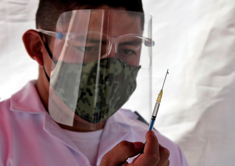 Medical staff administer the Pfizer/BioNTech vaccine against the coronavirus, at the Military Field Number 1A in Mexico City. Mexico will first apply the vaccine to all health personnel and the elderly as part of their mass immunization program. AFP