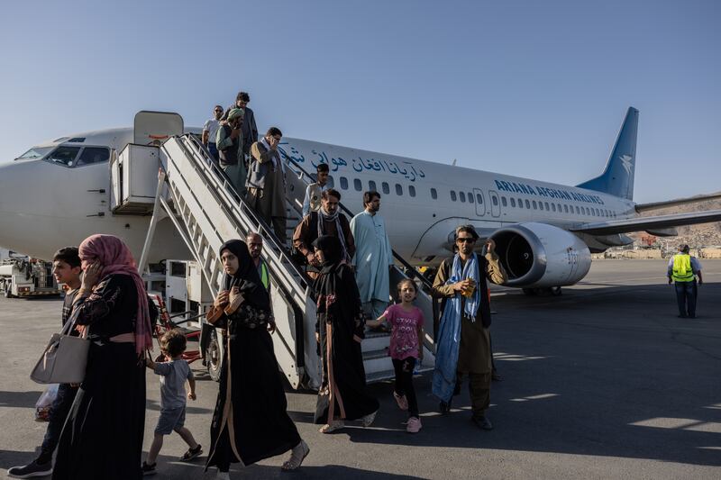 People disembark from the Ariana Afghan Airlines flight that landed in Kabul from Herat. Stefanie Glinski for The National