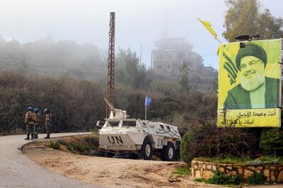 A United Nations Interim Forces in Lebanon (UNIFIL) armoured vehicle is parked under a portrait of Hezbollah leader Hassan Nasrallah on a side road in the southern Lebanese town of Kfar Kila near the border with Israel on January 3, 2020. Following this morning's killing of Iranian commander, Major General Qasem Soleimani, Lebanon's Iran-backed Hezbollah movement called for the missile strike by Israel's closest ally, to be avenged. "Meting out the appropriate punishment to these criminal assassins... will be the responsibility and task of all resistance fighters worldwide," Hezbollah chief Hassan Nasrallah said in a statement.
 / AFP / Ali DIA
