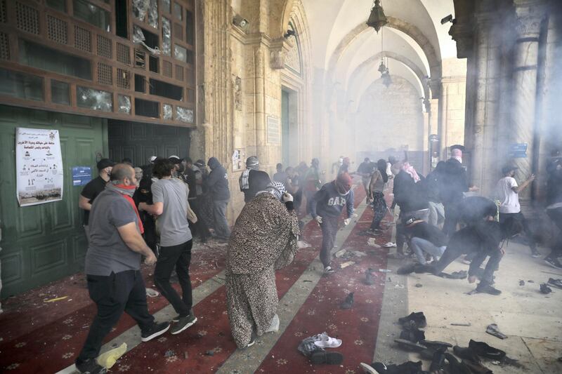 Palestinians clash with Israeli security forces at the Al Aqsa Mosque compound in Jerusalem's Old City Monday, May 10, 2021. Israeli police clashed with Palestinian protesters at a flashpoint Jerusalem holy site on Monday, the latest in a series of confrontations that is pushing the contested city to the brink of eruption. Palestinian medics said at least 180 Palestinians were hurt in the violence at the Al-Aqsa Mosque compound, including 80 who were hospitalized. (AP Photo/Mahmoud Illean)