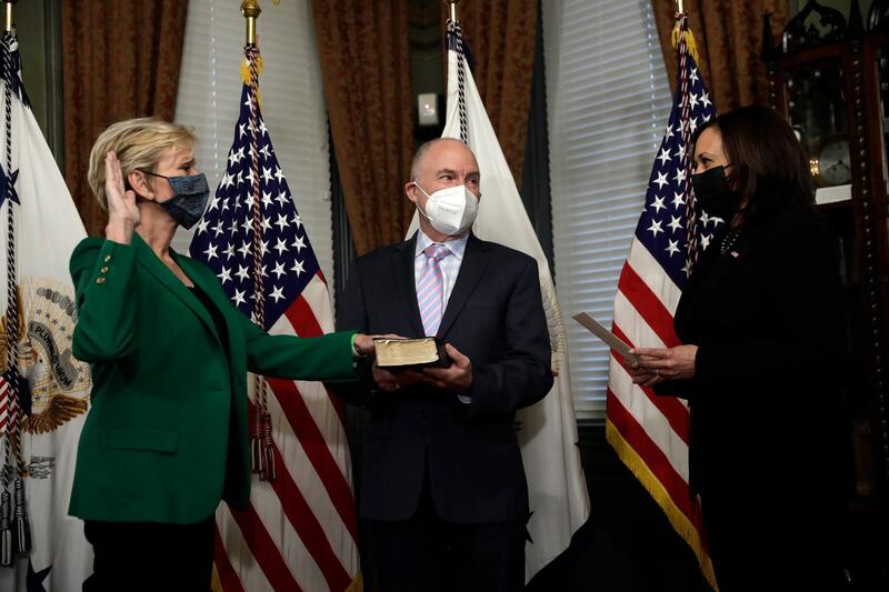 epa09037216 US Secretary of Energy Jennifer Granholm (L) is sworn in with her husband Dan Mulhern by Vice President Kamala Harris during a ceremony in the Eisenhower Executive Office Building at the White House in Washington, DC, USA, 25 February 2021.  EPA/Yuri Gripas / POOL