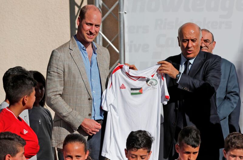 Head of the Palestinian Football Federation, Jibril Rajoub, offers a football jersey to Britain's Prince William in the West Bank city of Ramallah. Ahmad Gharabli / AFP