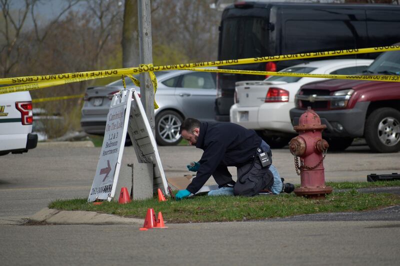 An investigator looks for evidence outside the Somers House Tavern in Somers, Wisconsin after a fatal shooting early on Sunday morning. AP