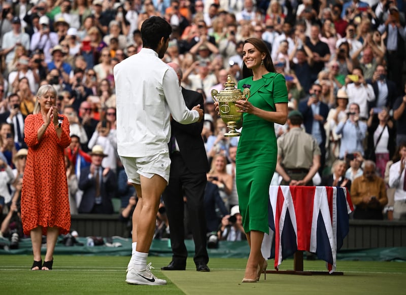 Spain's Carlos Alcaraz receives the trophy from Kate, the Princess of Wales. Reuters