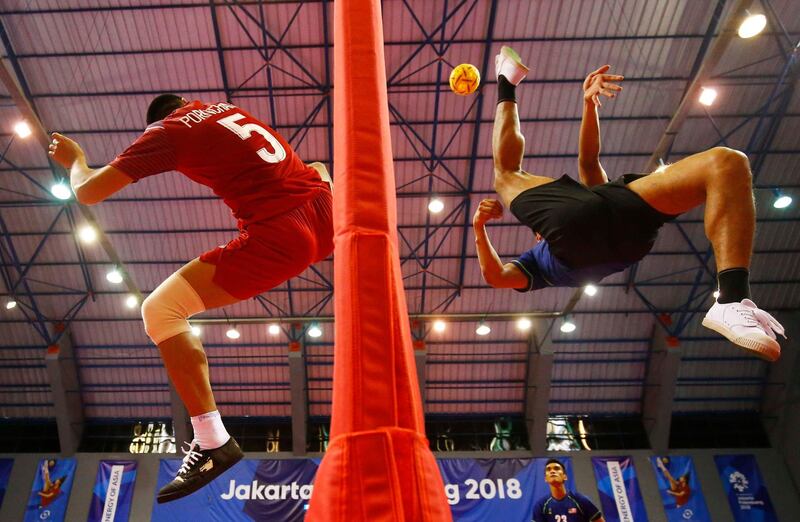 Pornchai Kaokaew of Thailand and Muhamad Norhaffizi Abd Razak of Malaysia in action during the Men's Team Regu Gold Medal Match at the Asian Games, Palembang, Indonesia. Reuters