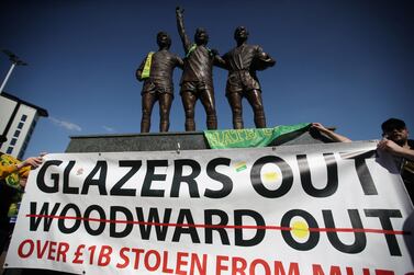 FILE PHOTO: Soccer Football - Manchester United fans protest against owners after failed launch of a European Super League - Old Trafford, Manchester, Britain - April 24, 2021 Manchester United fans gather by the Holt Trinity statue as they protest against owners outside Old Trafford after failed launch of a European Super League Action Images via Reuters/Carl Recine/File Photo