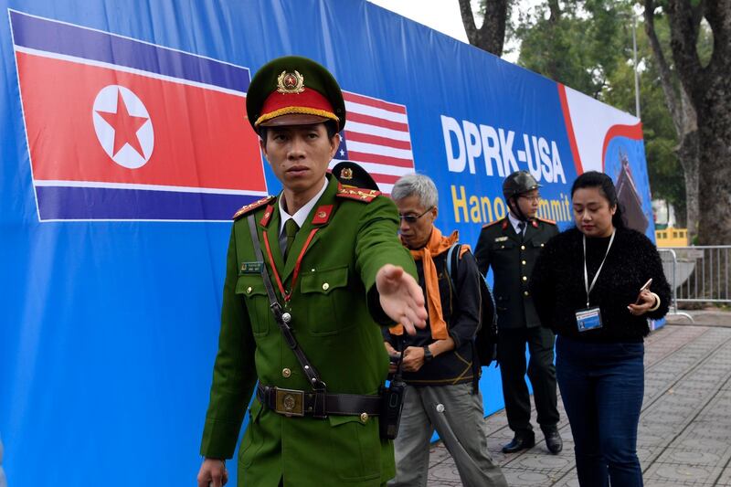 Vietnamese security moves people from the area where the motorcade with President Donald Trump will pass in Hanoi, Vietnam. AP Photo