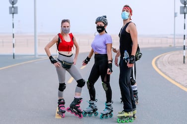 Abu Dhabi, United Arab Emirates, August 21, 2020. The Madrollers skating group at the Al Wathba Bicycle Track do a 8 km. fun sprint. The skating group has members from Dubai and Abu Dhabi. They encourage safety and discipline on roller-skates, skateboard, long-board and bicycles. (L-R) Lislotte, Rita and Chief strike a pose before the run. Victor Besa /The National Section: Photo Project Reporter: