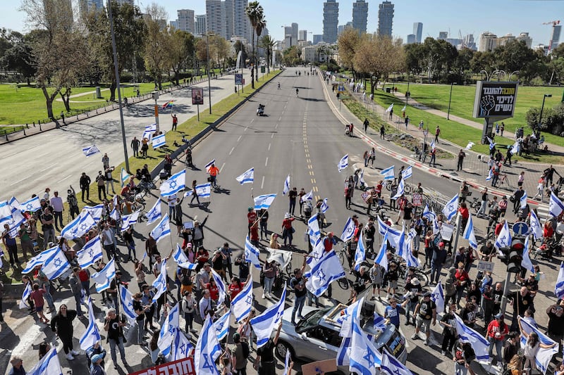 Demonstrators march at a rally against the Israeli government's judicial overhaul bill in Tel Aviv. AFP