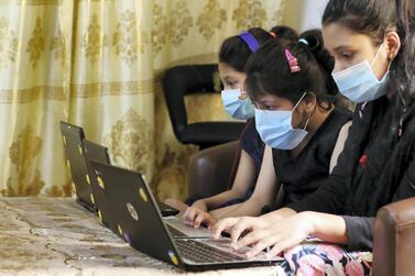 Atika, Aliza and Aiza Rehman work on their laptops at home in Dubai. Schools will break for the summer from the first weekend in July. Chris Whiteoak / The National