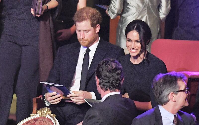 LONDON, ENGLAND - APRIL 21: Prince Harry and Meghan Markle take their seats at a star-studded concert to celebrate the Queen's 92nd birthday at the Royal Albert Hall on April 21, 2018 in London, England.  The Queen and members of the royal family are guests of honour at the celebration, which is being billed as The Queen's Birthday Party. (Photo by John Stillwell - WPA Pool/Getty Images)