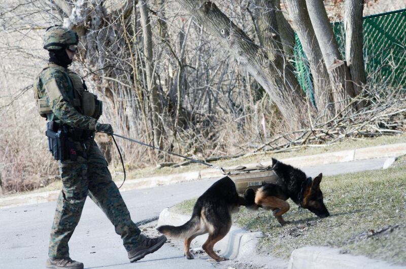 Police search neighborhoods near Central Michigan University for a 19-year-old student suspected of killing his parents at a dormitory and then running from campus, Friday, March 2, 2018 in Mount Pleasant, Mich. (Jacob Hamilton/The Bay City Times via AP)