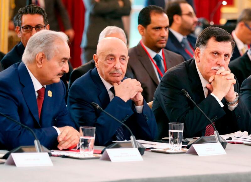 (FILES) In this file photo taken on May 29, 2018 (L to R) Libyan strongman Khalifa Haftar,  speaker of the eastern-based parliament Aguila Saleh Issa, and head of the Tripoli-based UN-recognised unity government Fayez al-Sarraj, attend an International Congress on Libya at the Elysee Palace in Paris. Libya's warring rival governments announced in separate statements signed by Sarraj, Saleh and Haftar on August 21, that they would cease all hostilities and organise nationwide elections soon, an understanding swiftly welcomed by the United Nations.
 / AFP / POOL / Etienne LAURENT
