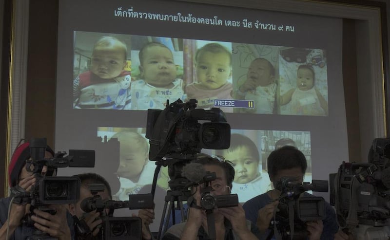 Thai police show photos of some of the 16 surrogate babies fathered by a Japanese buinessman during a press conference in Chonburi on August 12, 2014. Sakchai Lalit / AP Photo