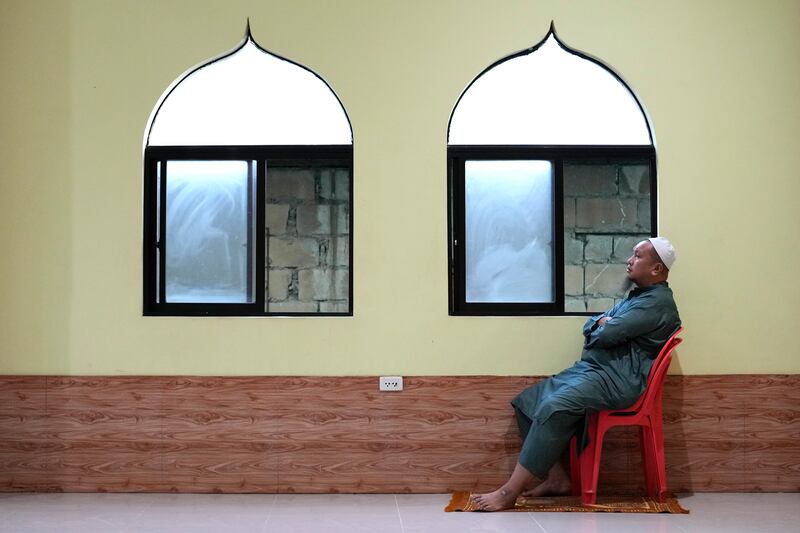 A man sits inside a mosque on the first day of Ramadan, in Marikina, the Philippines. AP