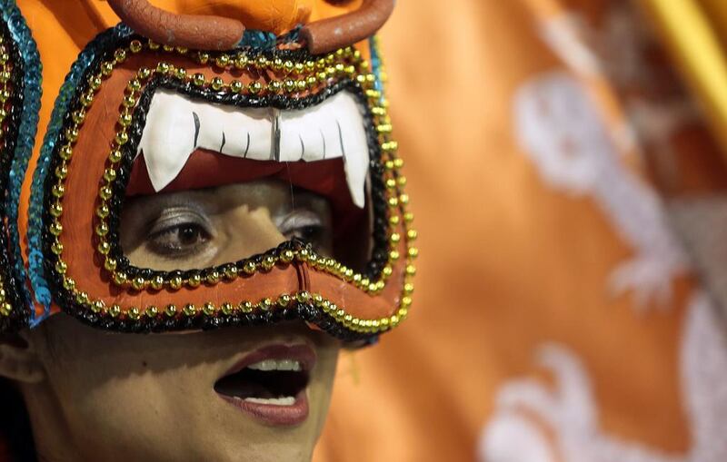 A reveller of the Perola Negra samba school performs. Miguel Schincariol / AFP Photo