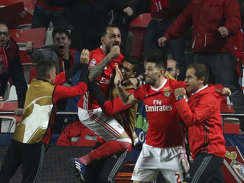 Benfica’s Kostas Mitroglou celebrates with teammates after scoring. Armando Franca / AP