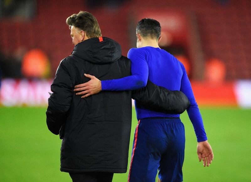 Manchester United manager Louis van Gaal congratulates striker Robin van Persie after their team's 2-1 Premier League win against Southampton on Monday. Mike Hewitt / Getty Images / December 8, 2014 
