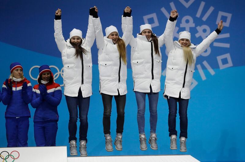 The team from Russia, bronze medalist in the women's 4 x 5km relay cross-country skiing, jump on the podium during the medals ceremony at the 2018 Winter Olympics in Pyeongchang, South Korea. Morry Gash / AP Photo