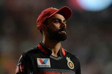 Royal Challengers Bangalore captain Virat Kohli looks on during the 2019 Indian Premier League (IPL) Twenty20 cricket match between Royal Challengers Bangalore and Rajasthan Royals at The M. Chinnaswamy Stadium in Bangalore early May 1, 2019. - Rajasthan Royals are chasing a target of 63 runs set by Royal Challengers Bangalore in 5 overs with a loss of 7 wickets as both team plays 5 overs each after rains delayed the start of the match. (Photo by Manjunath KIRAN / AFP) / ----IMAGE RESTRICTED TO EDITORIAL USE - STRICTLY NO COMMERCIAL USE----- / GETTYOUT