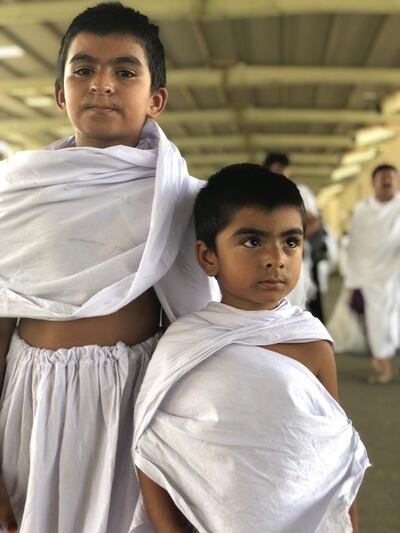 Young pilgrims pose for a photo while on their way to Mina from Makkah during Hajj. Balquees Basalom / The National