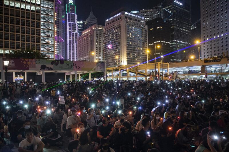Demonstrators shine lights from mobile devices and lasers during the International Humanitarian Aid Rally at Edinburgh Place in the Central district of Hong Kong, China. Bloomberg
