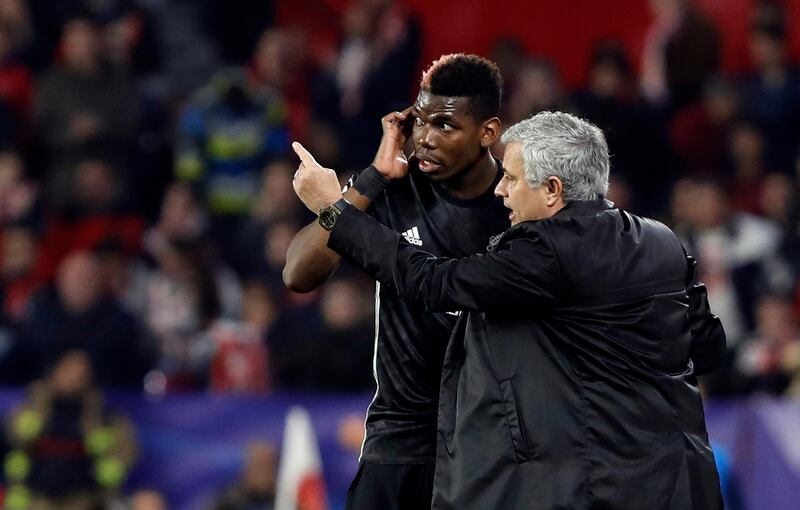 Manchester United manager Jose Mourinho, right, talks to Manchester United's Paul Pogba during the Champions League round of sixteen first leg soccer match between Sevilla FC and Manchester United at the Ramon Sanchez Pizjuan stadium in Seville, Spain, Wednesday, Feb. 21, 2018. (AP Photo/Miguel Morenatti)