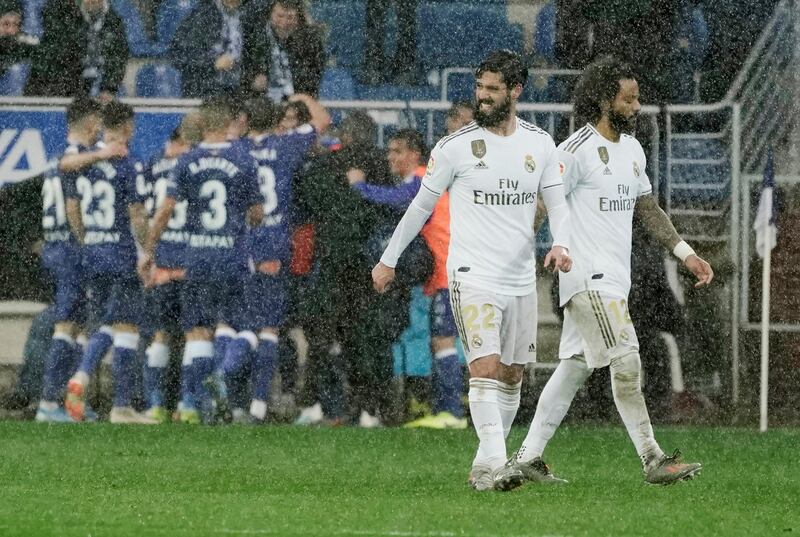 Real Madrid's Marcelo and Isco look dejected as Lucas Perez celebrates scoring. Reuters