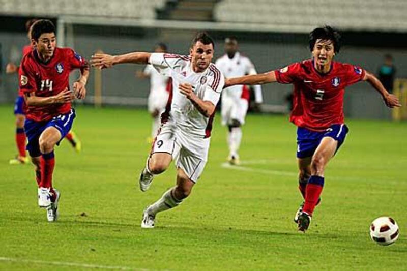 Al Jazira’s Bare, centre, vies for the ball with Jung-soo Lee, left, and Tae-hwi Kwak, of South Korea.